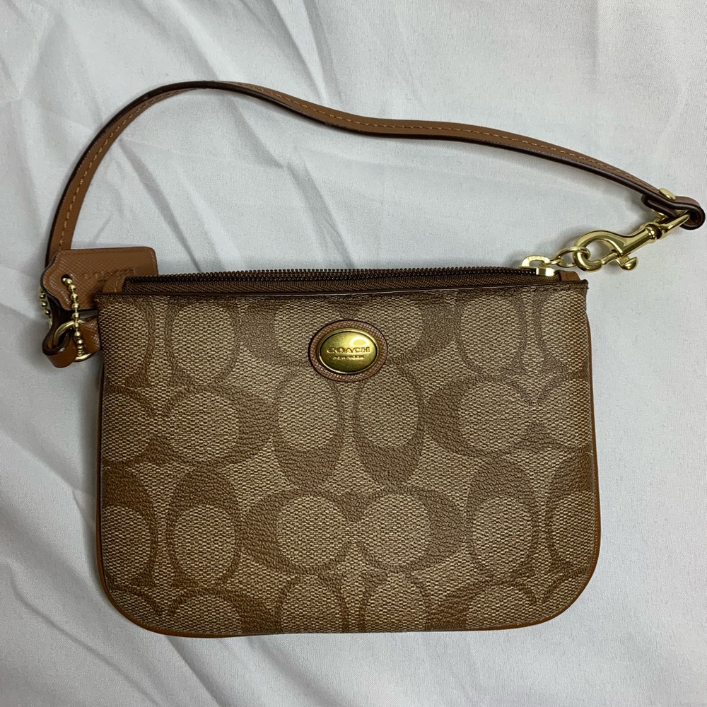 Brown coach wristlet with monogram logo